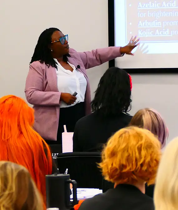 Skin Script home page classes and events image of Stacy teaching.