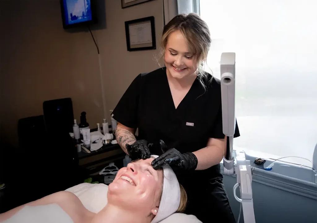 Aesthetician of the Month December 2025 Lauren Hybels performing a facial on a client.